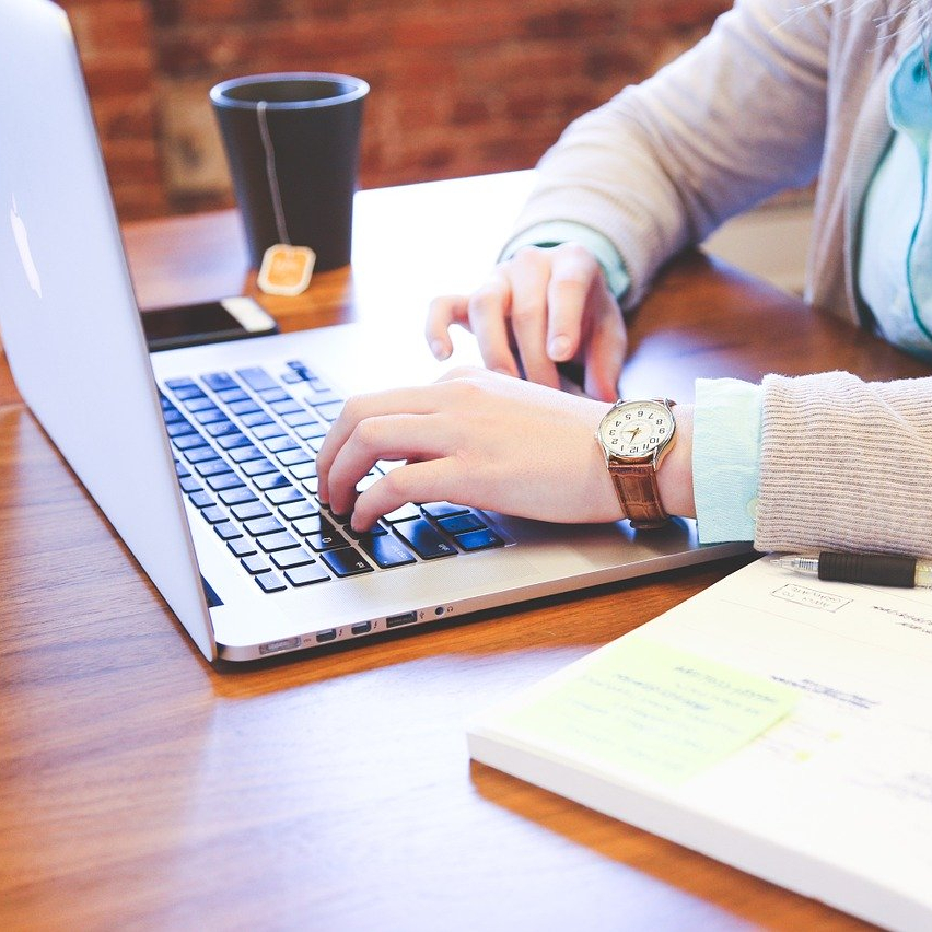 Student working with laptop and a hot drink